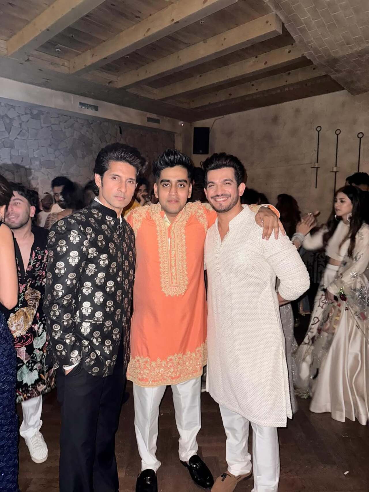 All smiles as Ravie and Arjun pose with Raghav at the Diwali party
