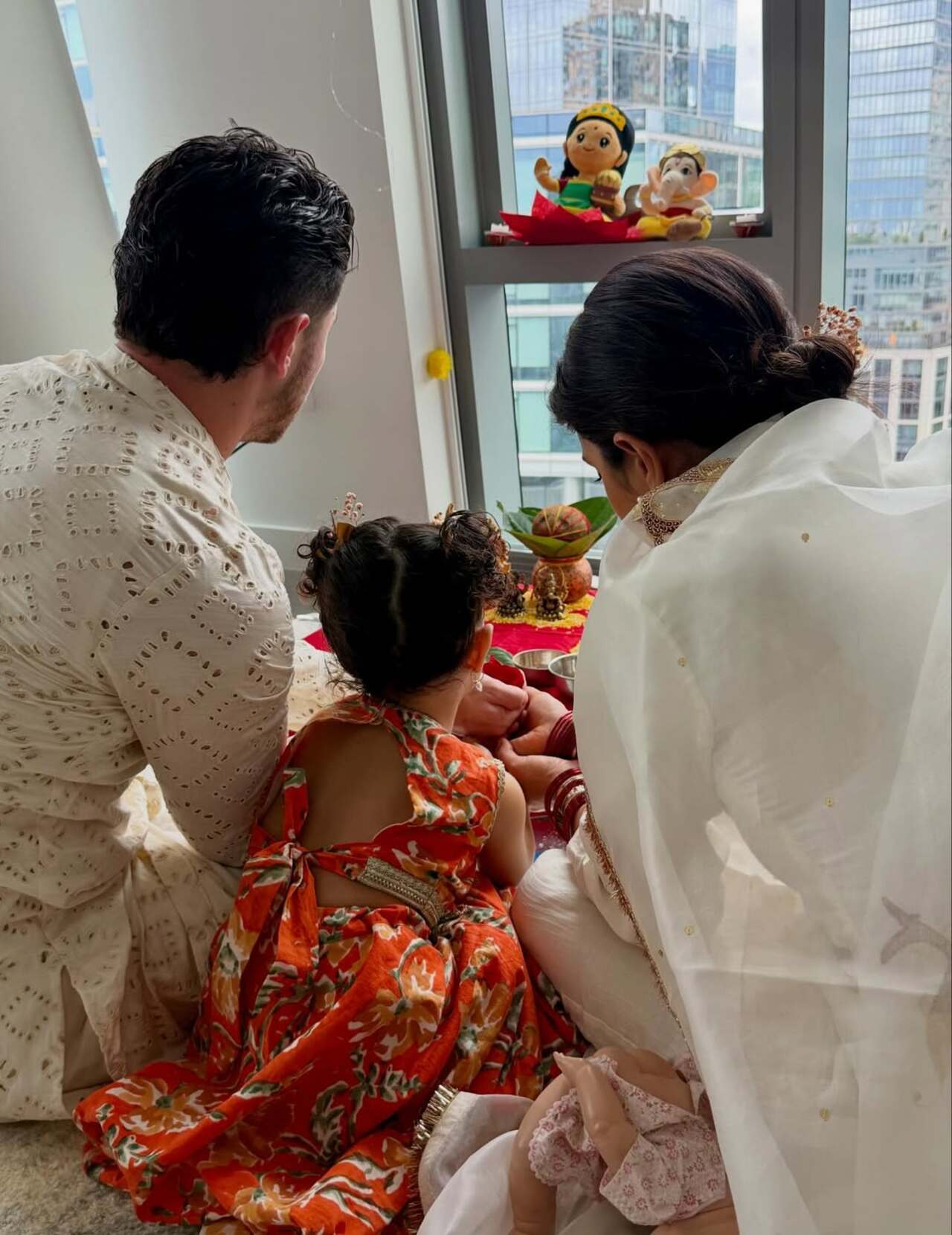 The day begins with the whole family sitting for Lakshmi Puja, aren't they adorable?