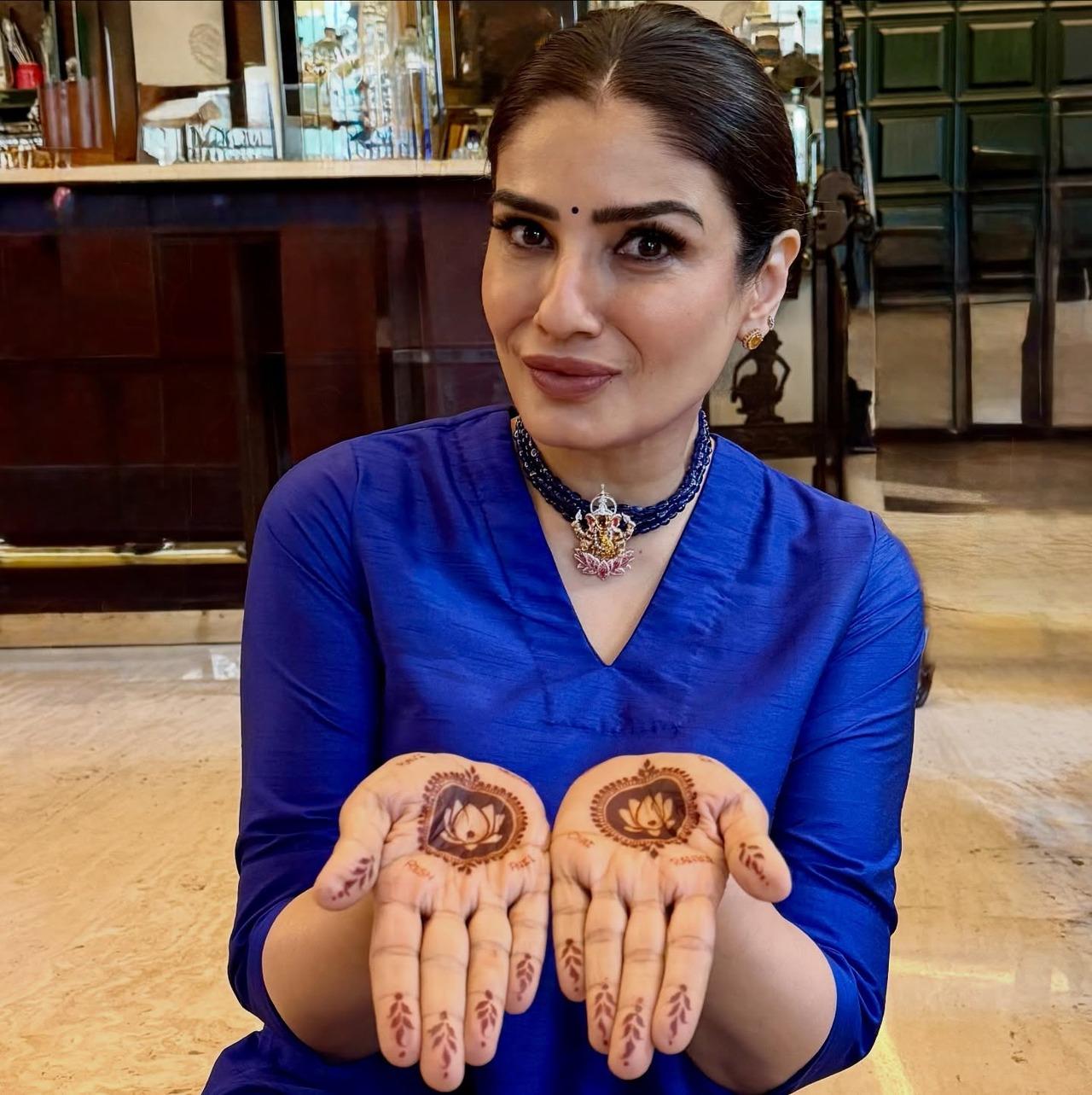 Raveena Tandon shared a picture posing with her mehendi in preparation of Karwa Chauth. She also shared a close-up picture of her mehendi which had names of her husband as well as her kids written on her palm
 