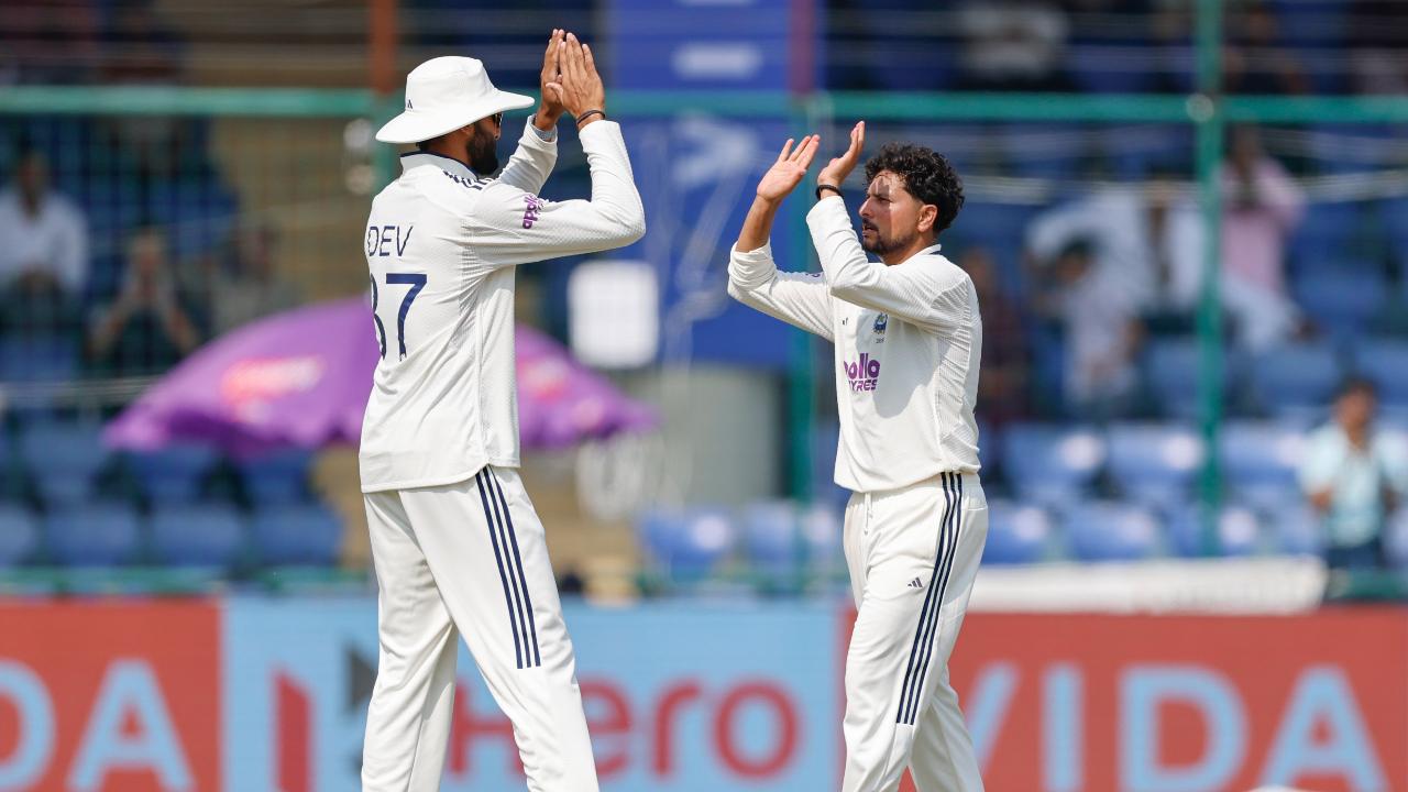 IND vs WI 2nd Test: Kuldeep Yadav, Jasprit Bumrah's three-wicket hauls help India bowl out Windies for 390 runs