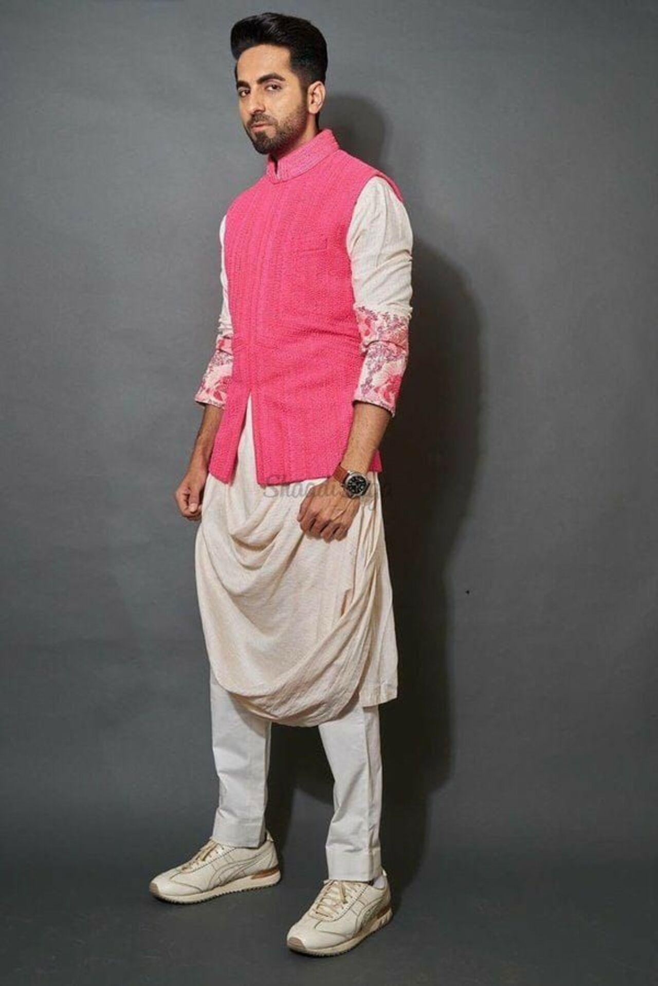 Ayushmann Khurrana shows how to wear pink without looking too bright or girlie. He pairs his cream kurta with a pink bandgala waistcoat.