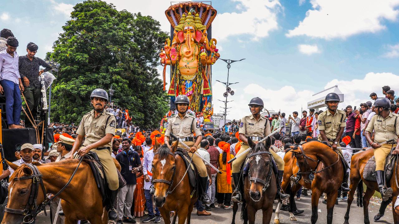 In Telangana's capital city, horse-mounted police personnel kept watch during the procession
