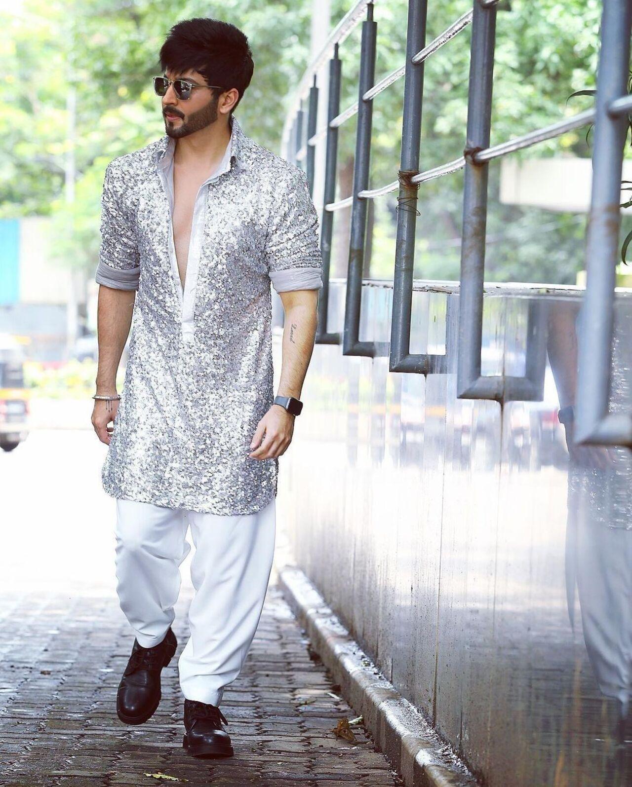 Dheeraj Dhoopar's sequinned grey kurta brings on the festive vibe. The salwar pants add a layer of traditional charm to the outfit.