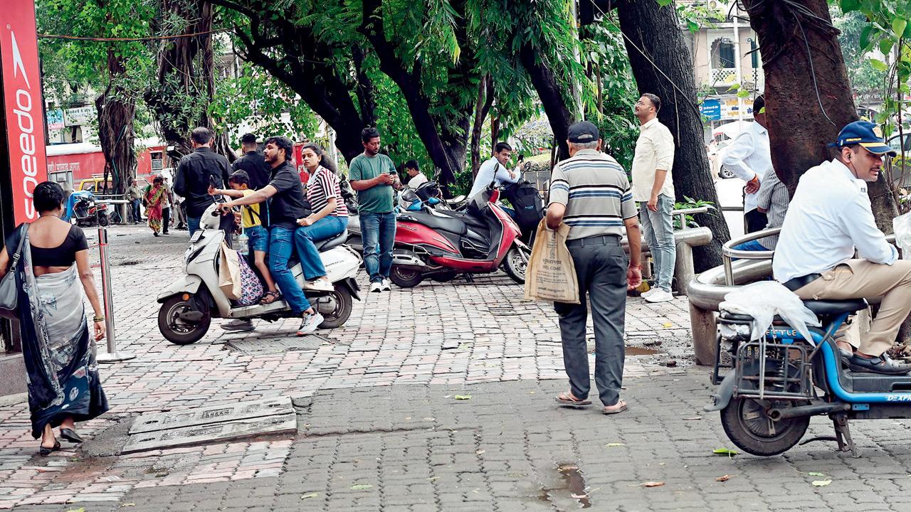 Scooters parked on the footpath near BA Road, with a traffic policeman seen resting on one of the vehicles