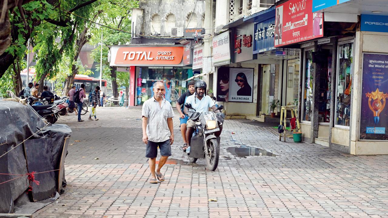 A biker misuses the footpath at Dadar TT, sparking complaints from residents. Pic/Atul Kamble