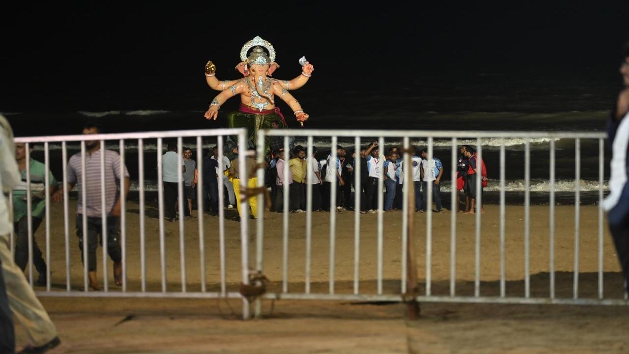 






The immersion process was conducted under heightened security, with devotees kept behind barricades. Civic workers carried out the actual immersion to ensure safety and smooth proceedings






