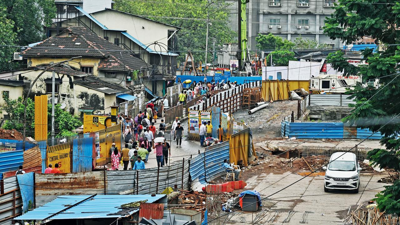 Partial demolition work underway at Sion bridge, with a section retained for pedestrian movement. Pic/Atul Kamble