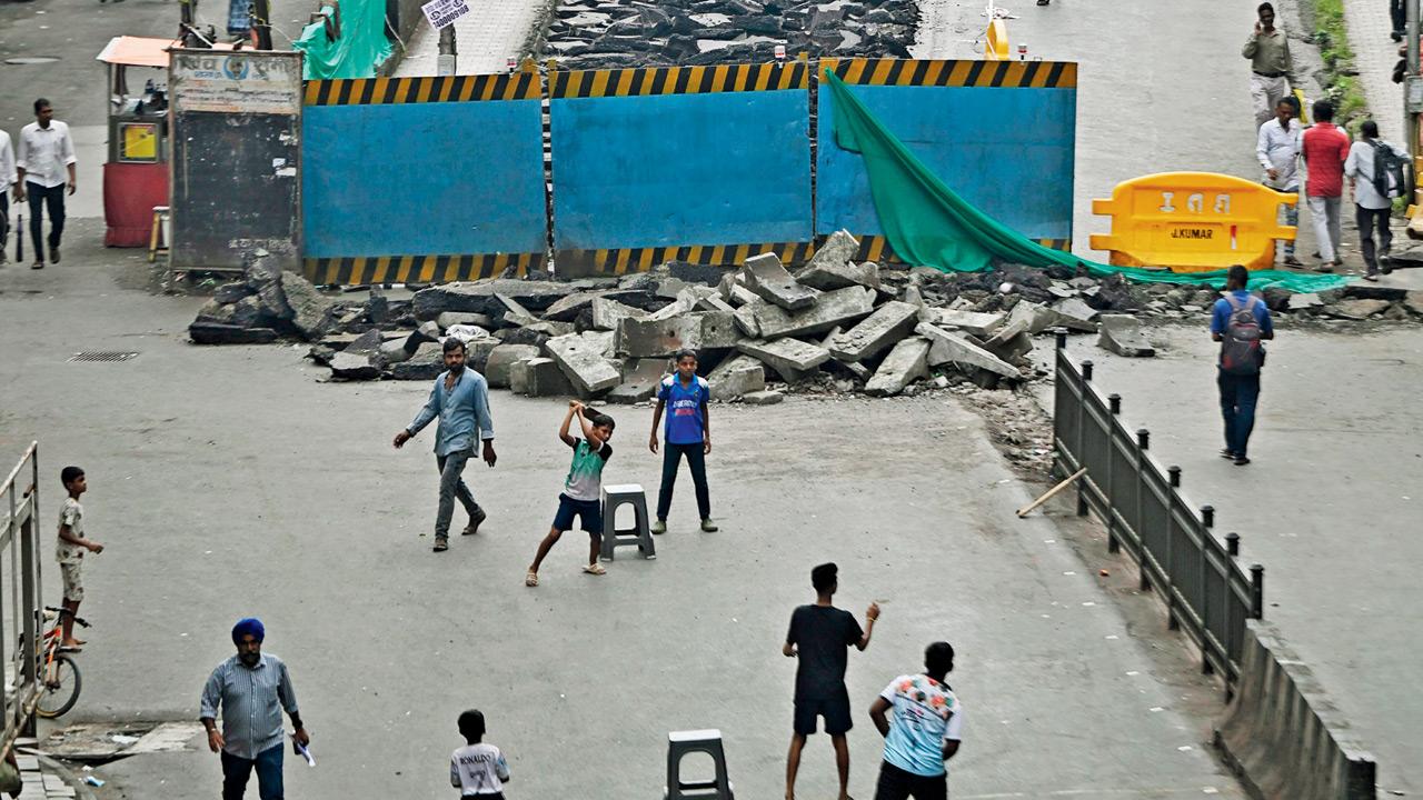 Children play cricket at the entrance to the partially demolished Elphinstone bridge, on Sunday. Pic/Ashish Raje