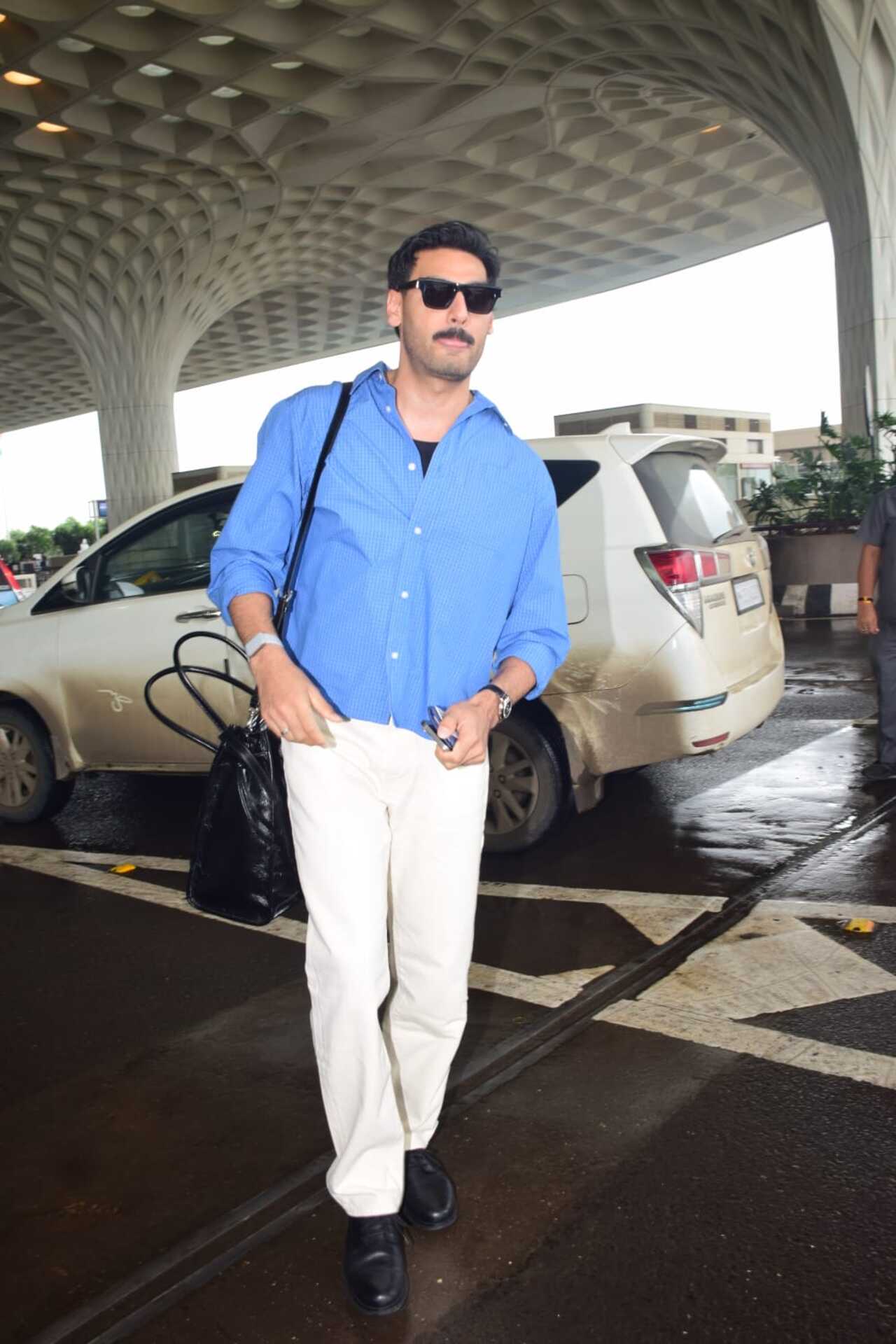 Ahan Shetty is giving the cool boy vibes with his loose blue shirt and white pants