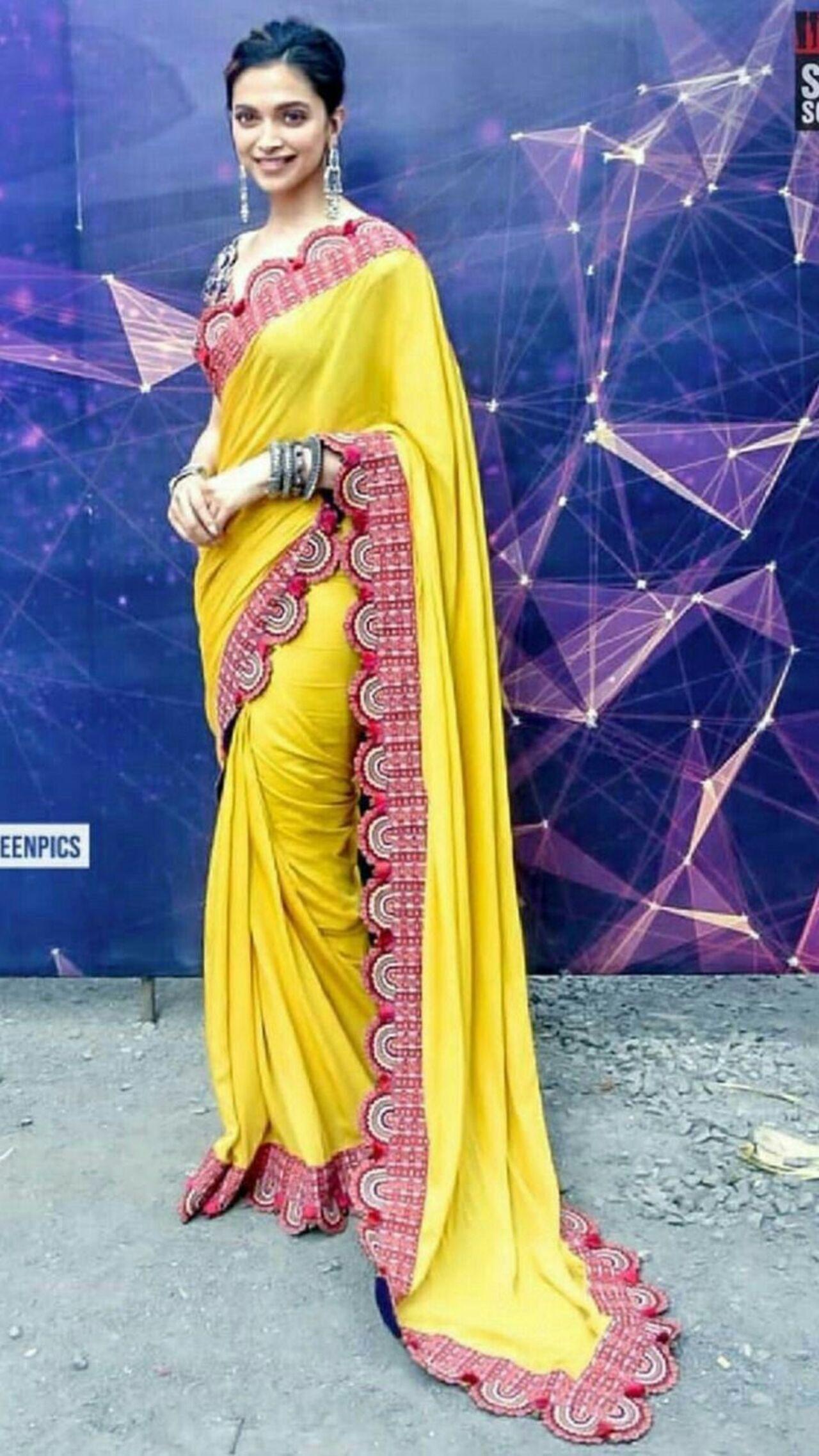 Deepika brought in festive vibes in this yellow saree with a scalloped embroidered border. Her dark blue, heavily embroidered blouse was a nice contrast to the saree.