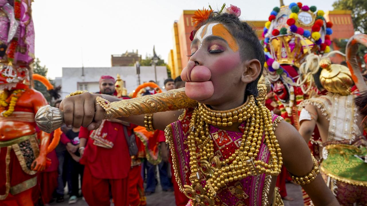 A young devotee dressed as Lord Hanuman takes part in the 'Langur Mela' celebration. Photo Courtesy: PTI