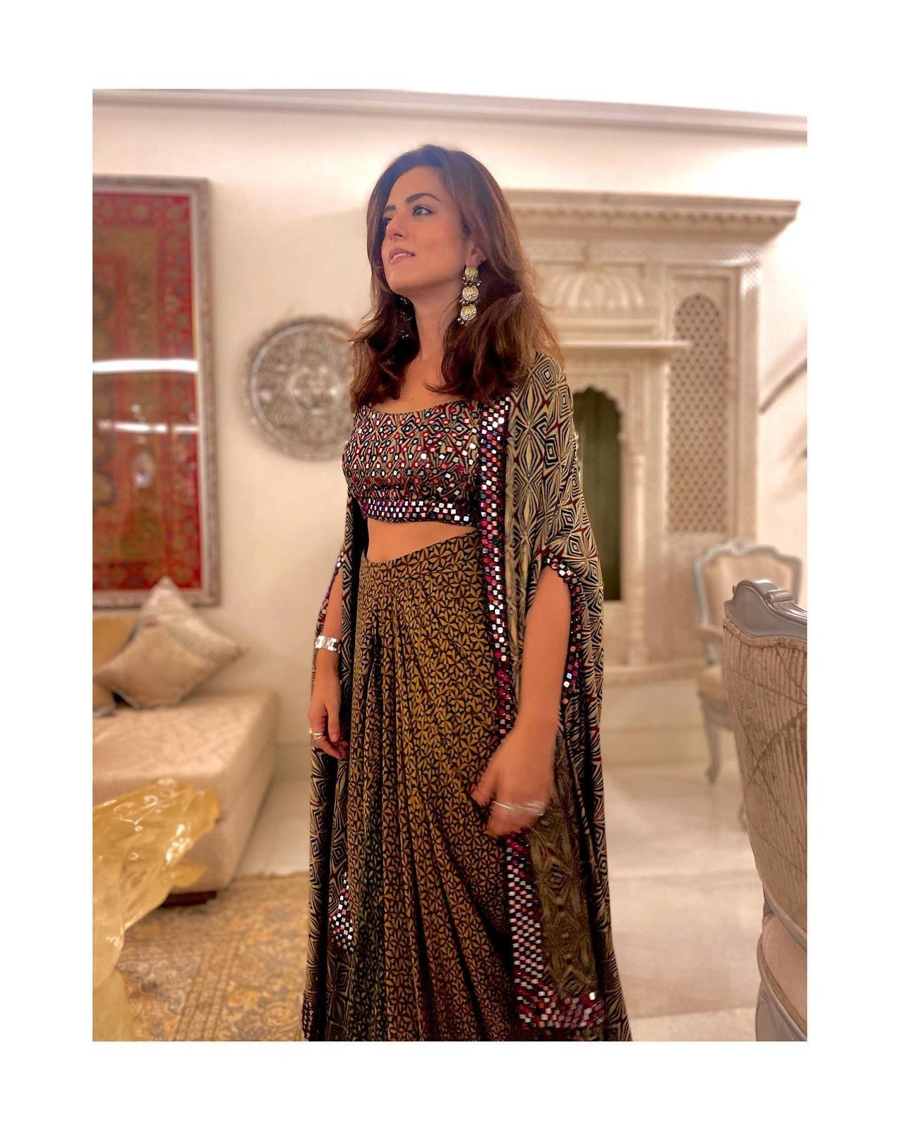 Another great festive pick from Rishi's wardrobe is this draped skirt with matching blouse and cape.