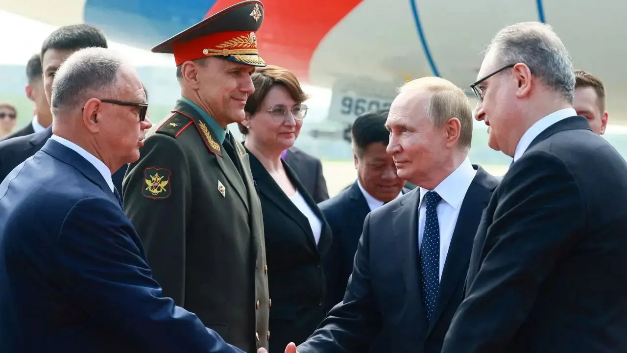Russia`s President Vladimir Putin shakes hands. Pic/AFP