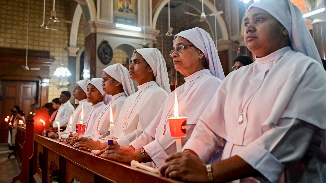 Nuns light candles during midnight mass prayer on Easter, at a church in Uttar Pradesh