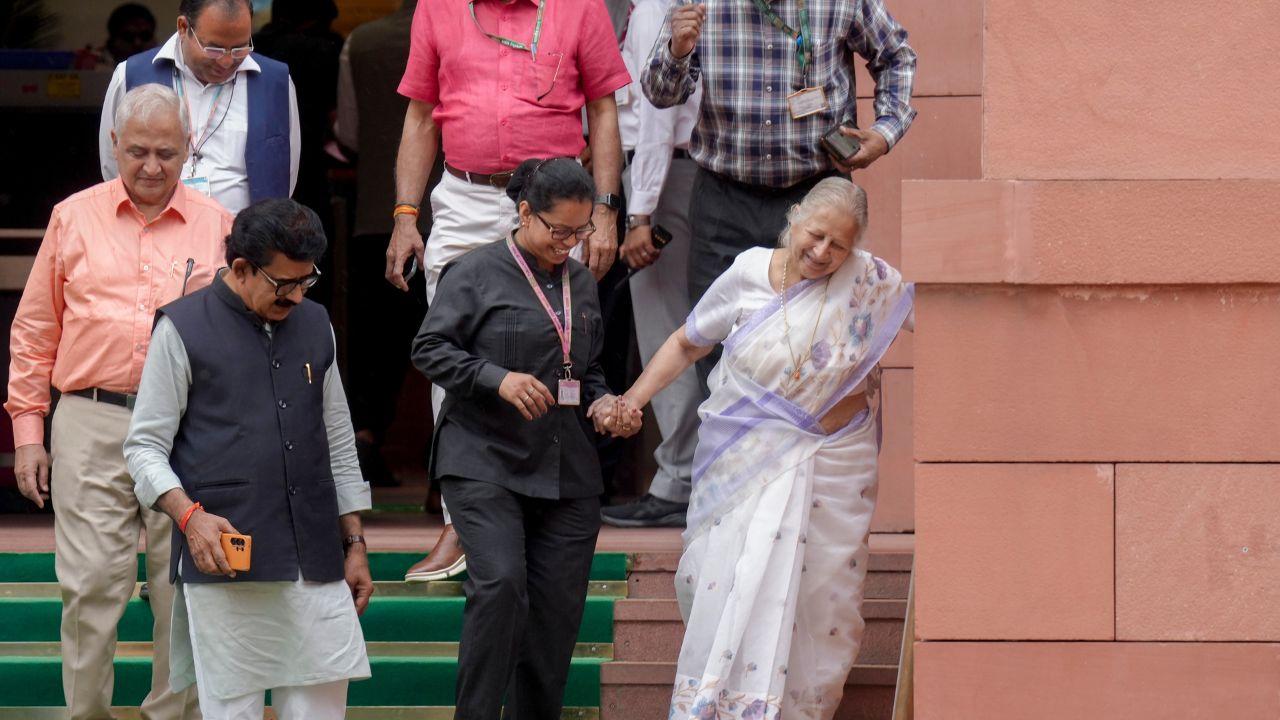 Former Lok Sabha speaker Sumitra Mahajan, front right, being assistes as she walks down the stairs during the Special session of Parliament