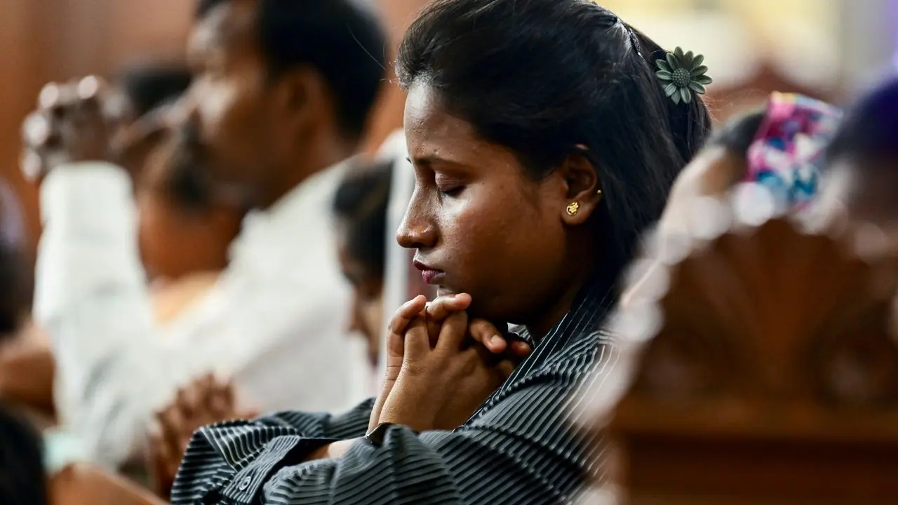 People offer prayers during a midnight mass on Easter, in Prayagraj, early Sunday