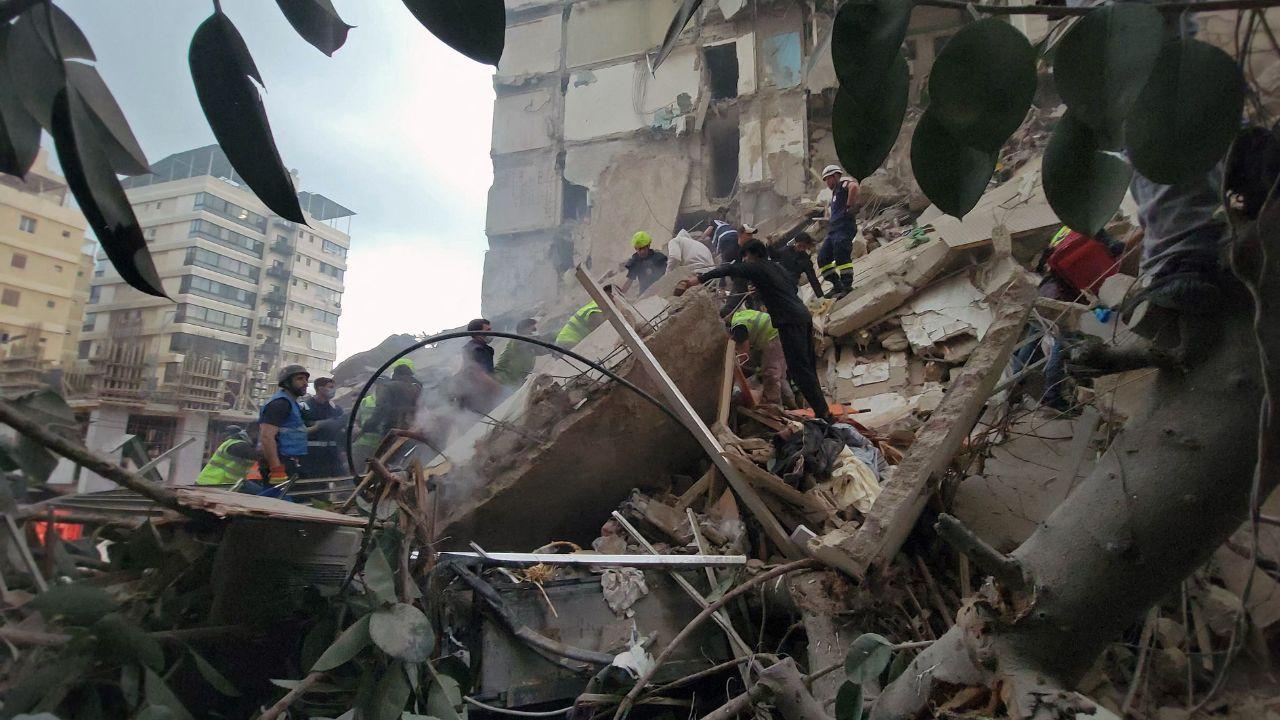 First responders and residents gather at the site of an Israeli airstrike in Beirut's Tallet al-Khayyat neighbourhood.