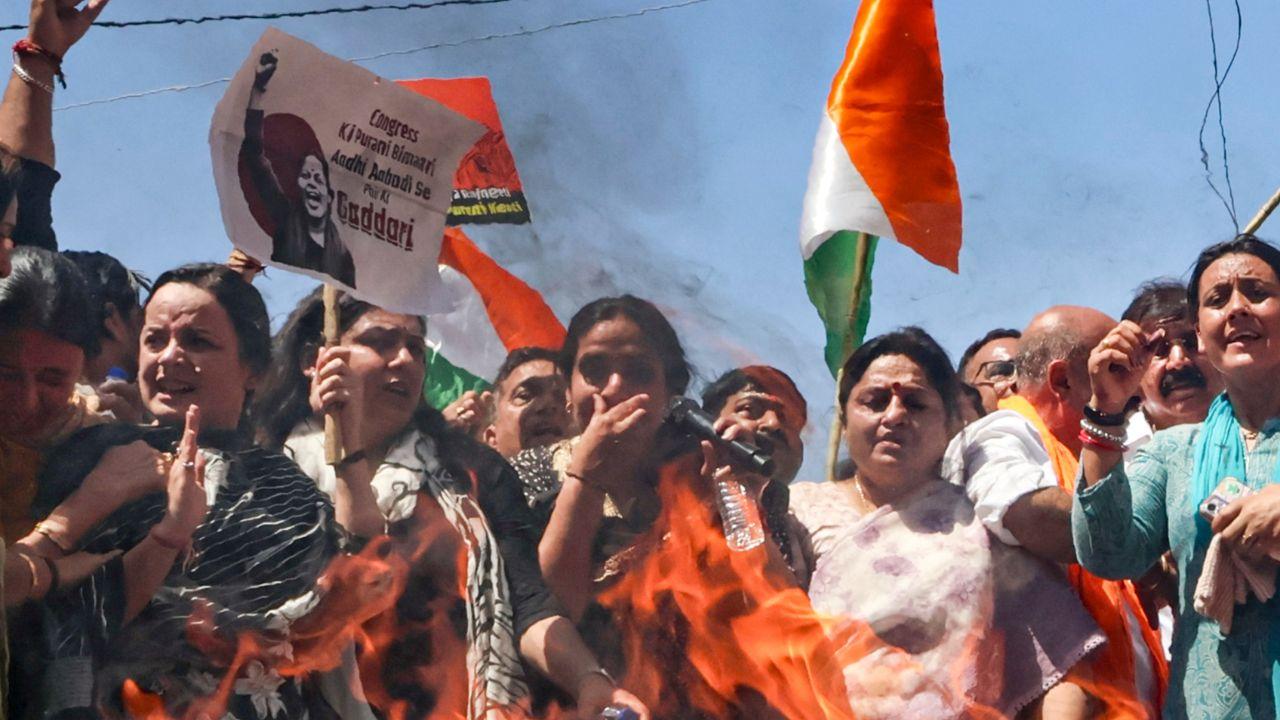 BJP workers burn effigies of opposition leaders, including Rahul Gandhi and Akhilesh Yadav, during the demonstration