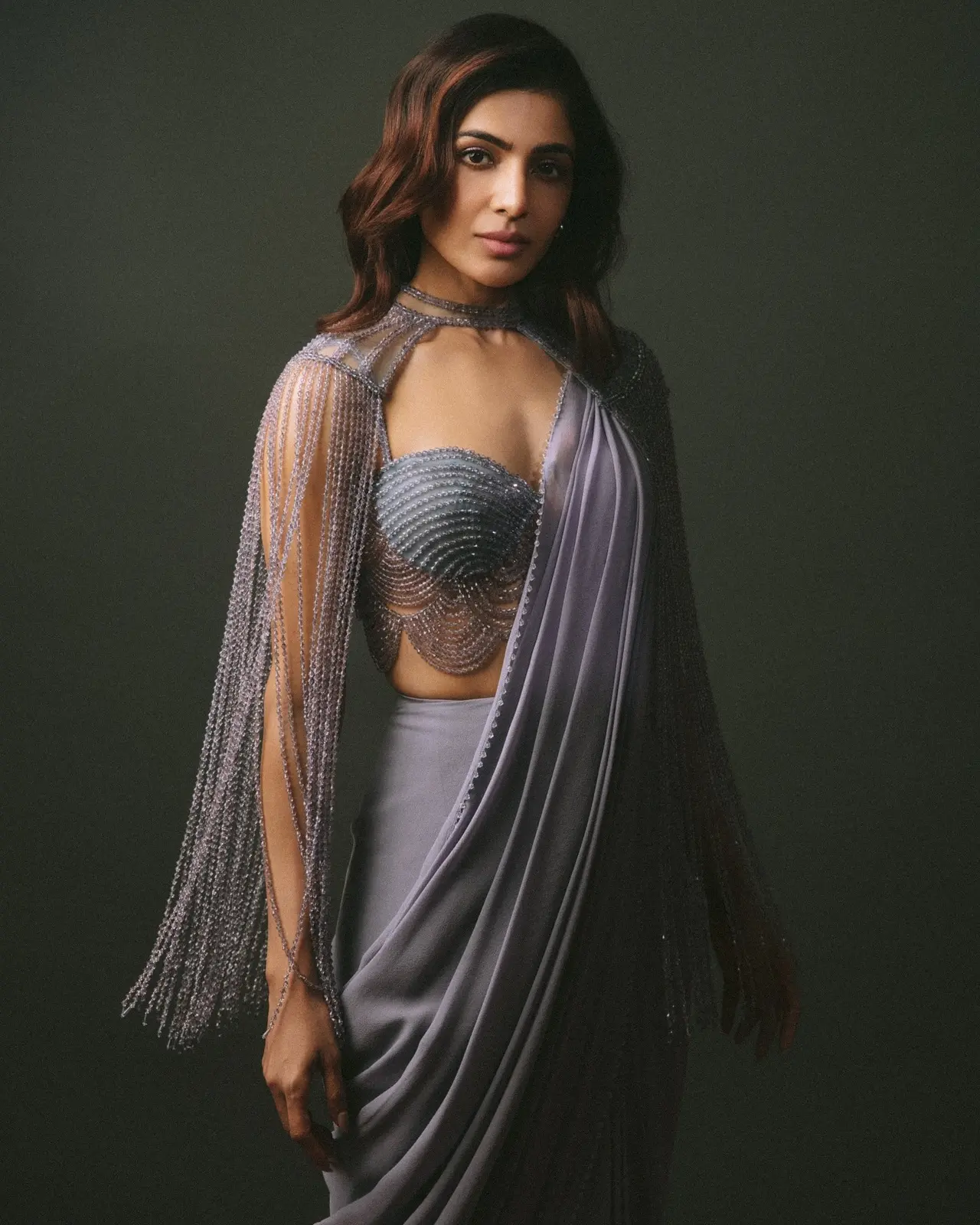 Samantha Ruth Prabhu looks effortlessly glamorous in this soft grey saree with a modern twist. The highlight is her embellished blouse with delicate chain details.