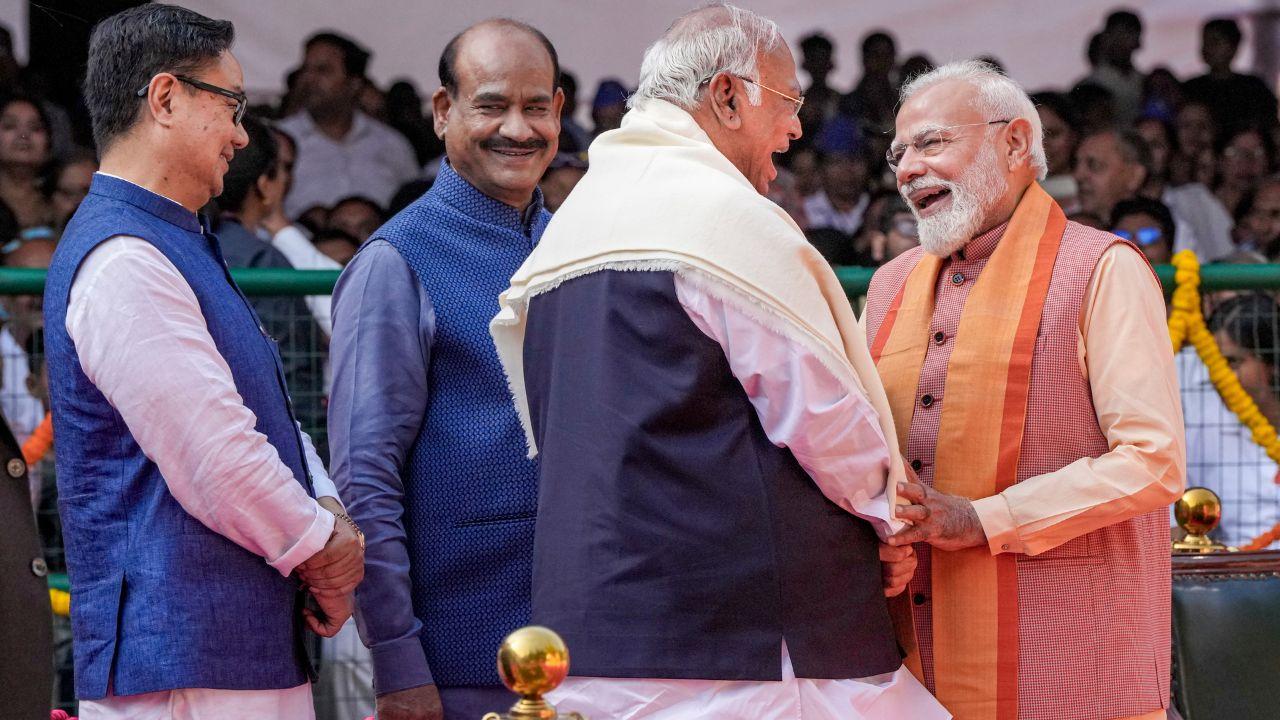 Prime Minister Narendra Modi in conversation with Congress President and Rajya Sabha LoP Mallikarjun Kharge during the tribute paying ceremony to Dr BR Ambedkar on his birth anniversary