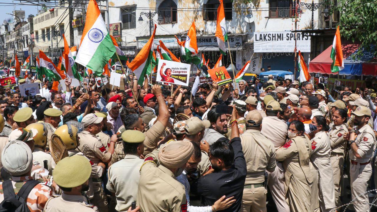 Security personnel erect barricades and deploy forces to prevent the BJP rally from reaching the Congress office, avoiding a direct confrontation