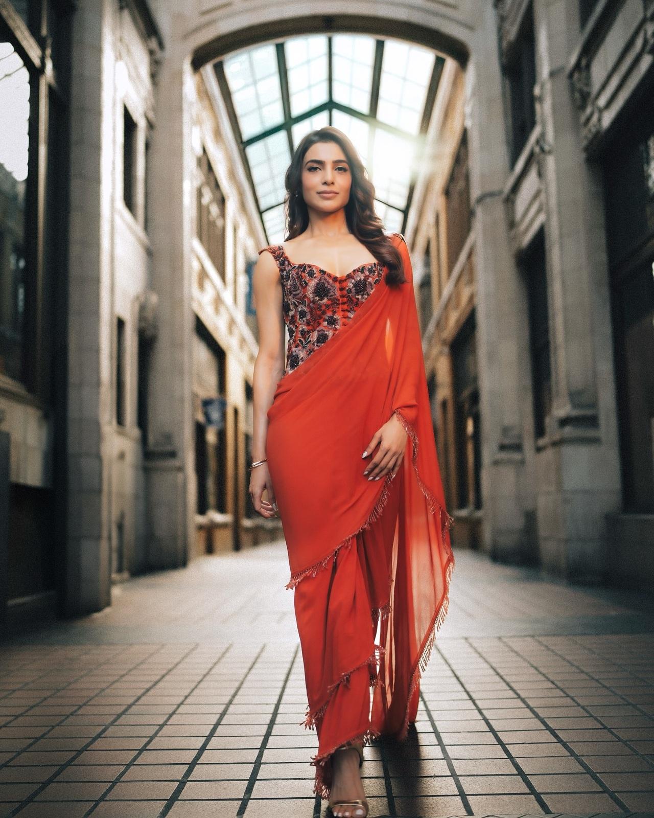 Samantha looks stunning in a vibrant red saree that perfectly blends elegance with bold style. The embroidered blouse adds a touch of glamour.