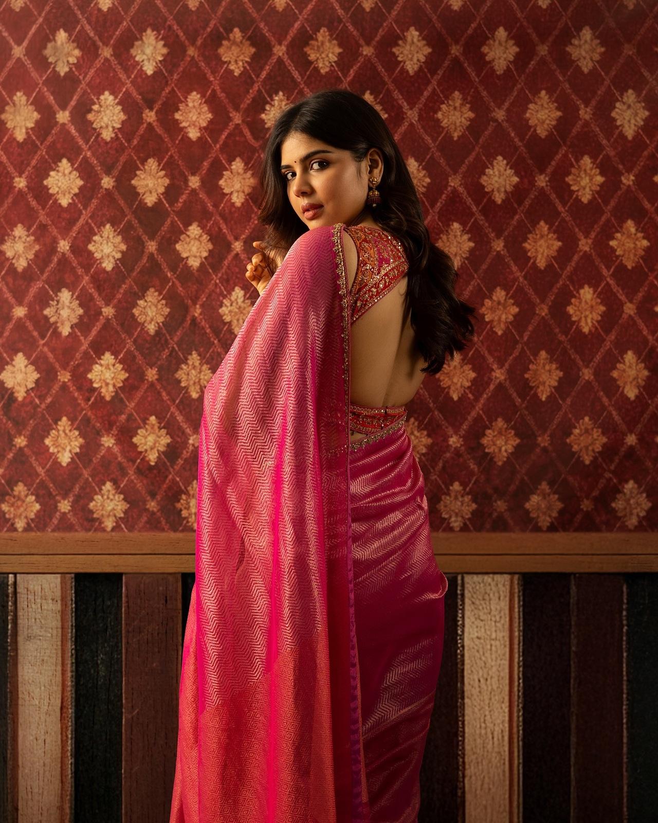 Kalyani Priyadarshan dazzles in a shimmery pink saree paired with a bold red blouse, striking the perfect balance between traditional charm and modern glamour.