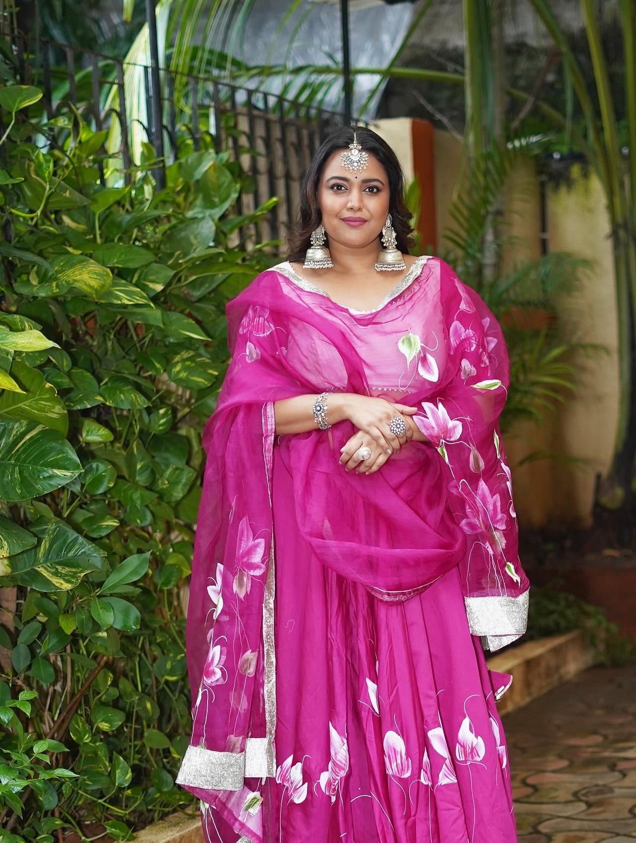 <p>Swara Bhaskar looks stunning in this rani pink organza lehenga, which features delicate hand-painted floral motifs and a shimmering silver border. She accessorizes the look with statement silver earrings and a traditional maang tikka.</p>
