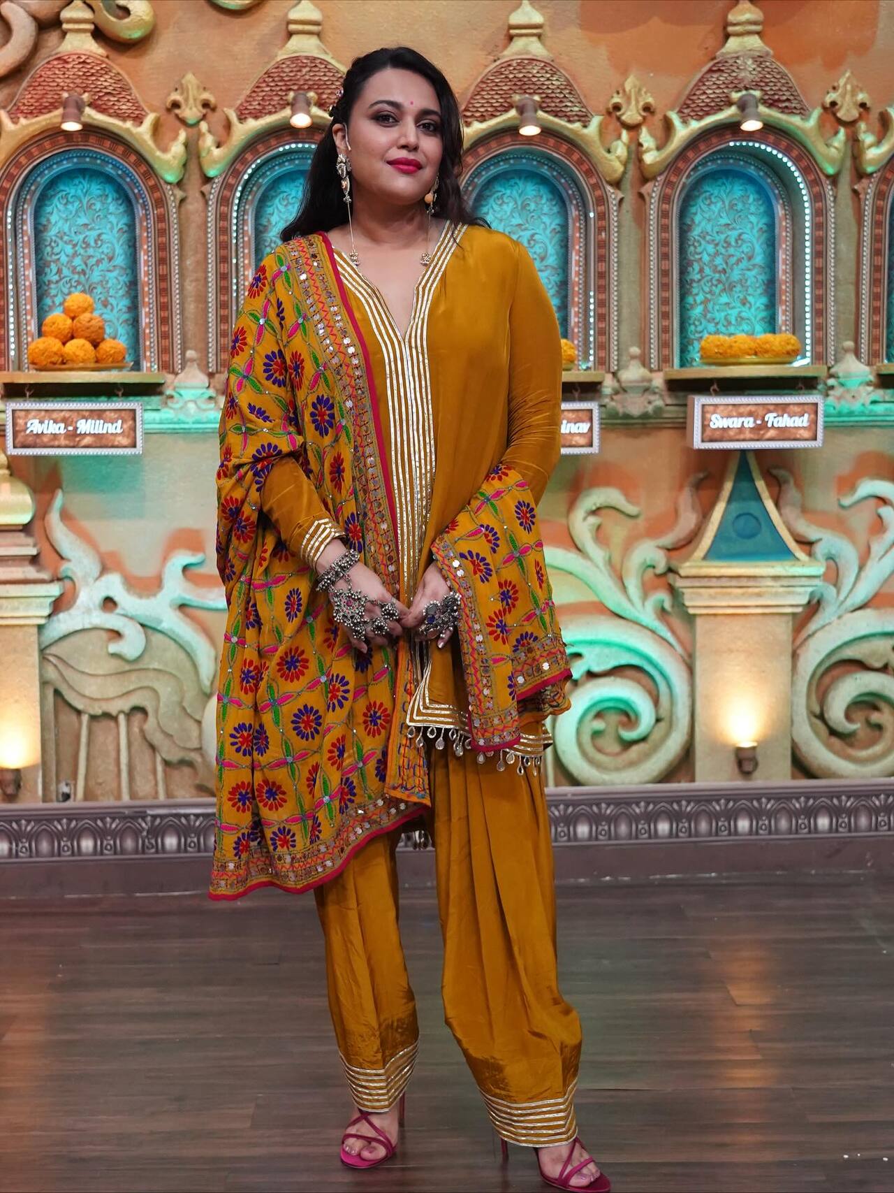 <p>Swara Bhaskar makes a bold statement in this mustard-yellow silk salwar kameez. The ensemble is paired with a heavily embroidered Phulkari-style dupatta, featuring vibrant floral motifs.</p>