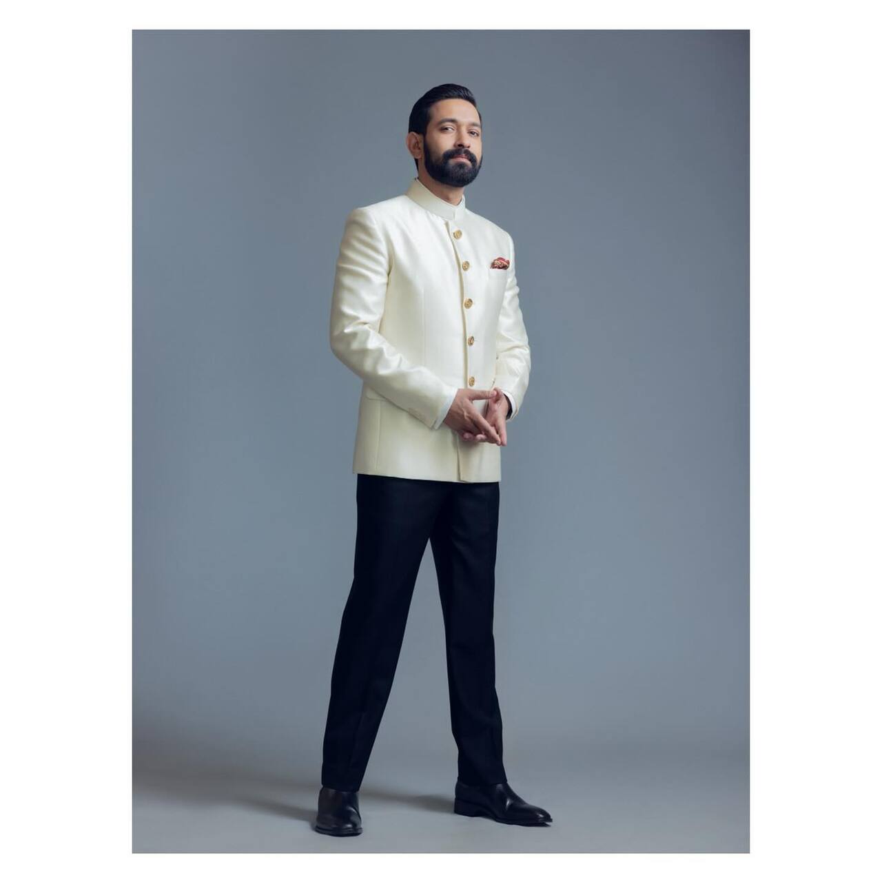 Vikrant Massey exudes timeless elegance in this sophisticated look, donning a classic ivory bandhgala jacket paired with tailored black trousers.