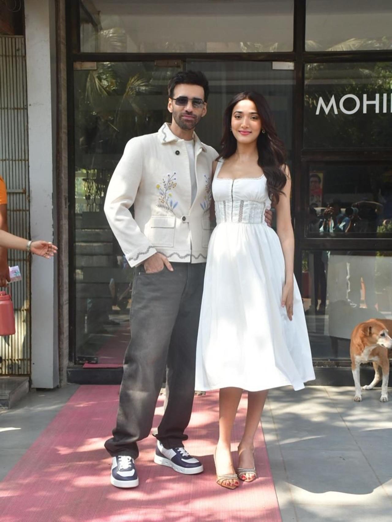Medha Shankr opts for a crisp, minimalist look during a promotional appearance for Ginny Wedss Sunny 2. She wears a clean white midi dress that features a fitted, corset-style bodice with flowing skirt and simple accessories.