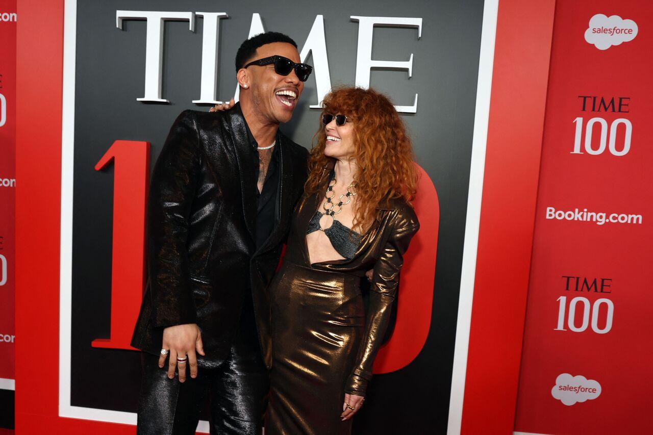 Natasha Lyonne brought her signature edgy flair to the TIME 100 red carpet in a metallic bronze Schiaparelli gown featuring a plunging neckline and a bold detail at the chest. She poses with Anderson Paak.