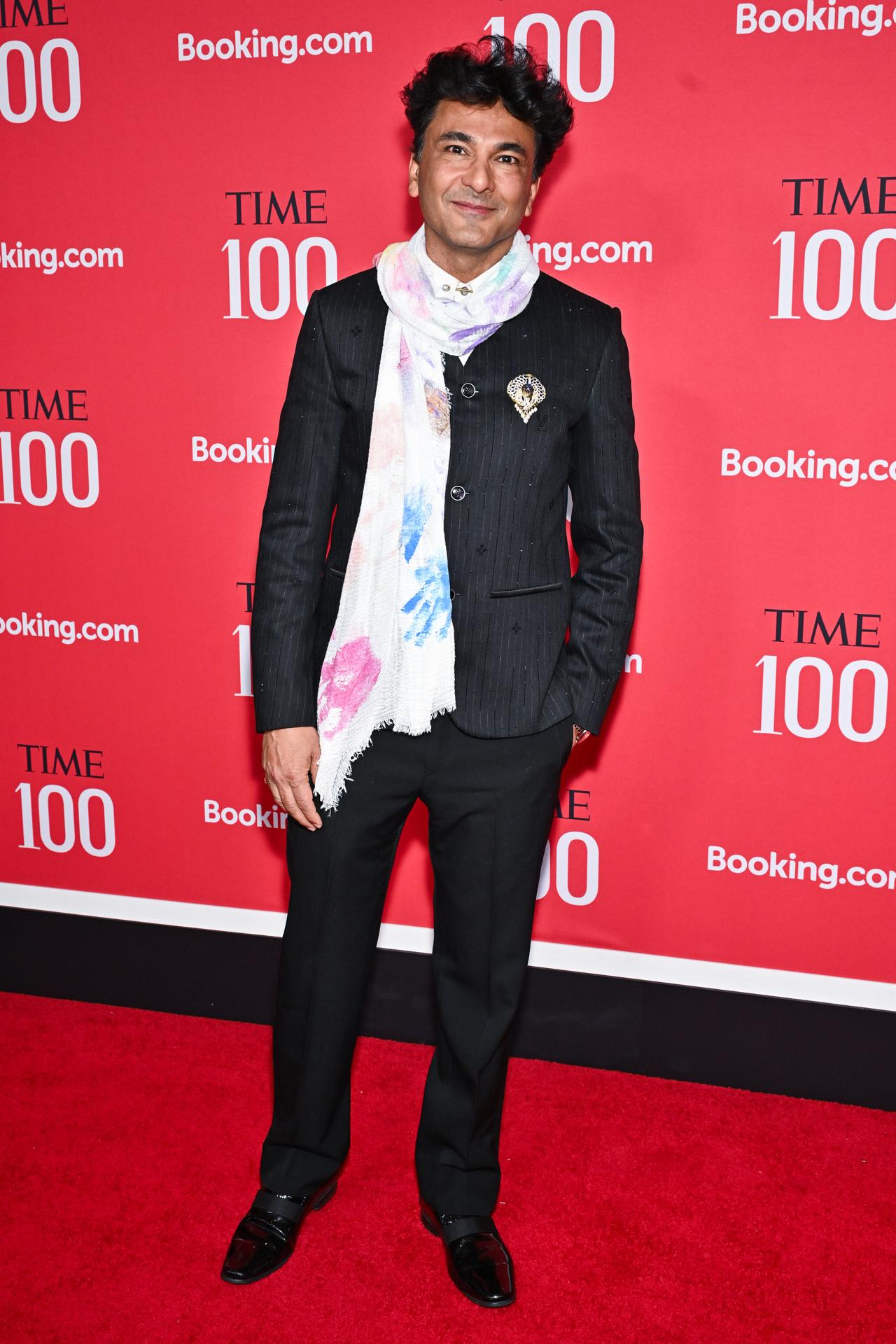 Chef Vikas Khanna brought a personal and artistic touch to the TIME 100 Gala, wearing a sharp, pinstriped black suit paired with a striking, hand-painted white scarf.