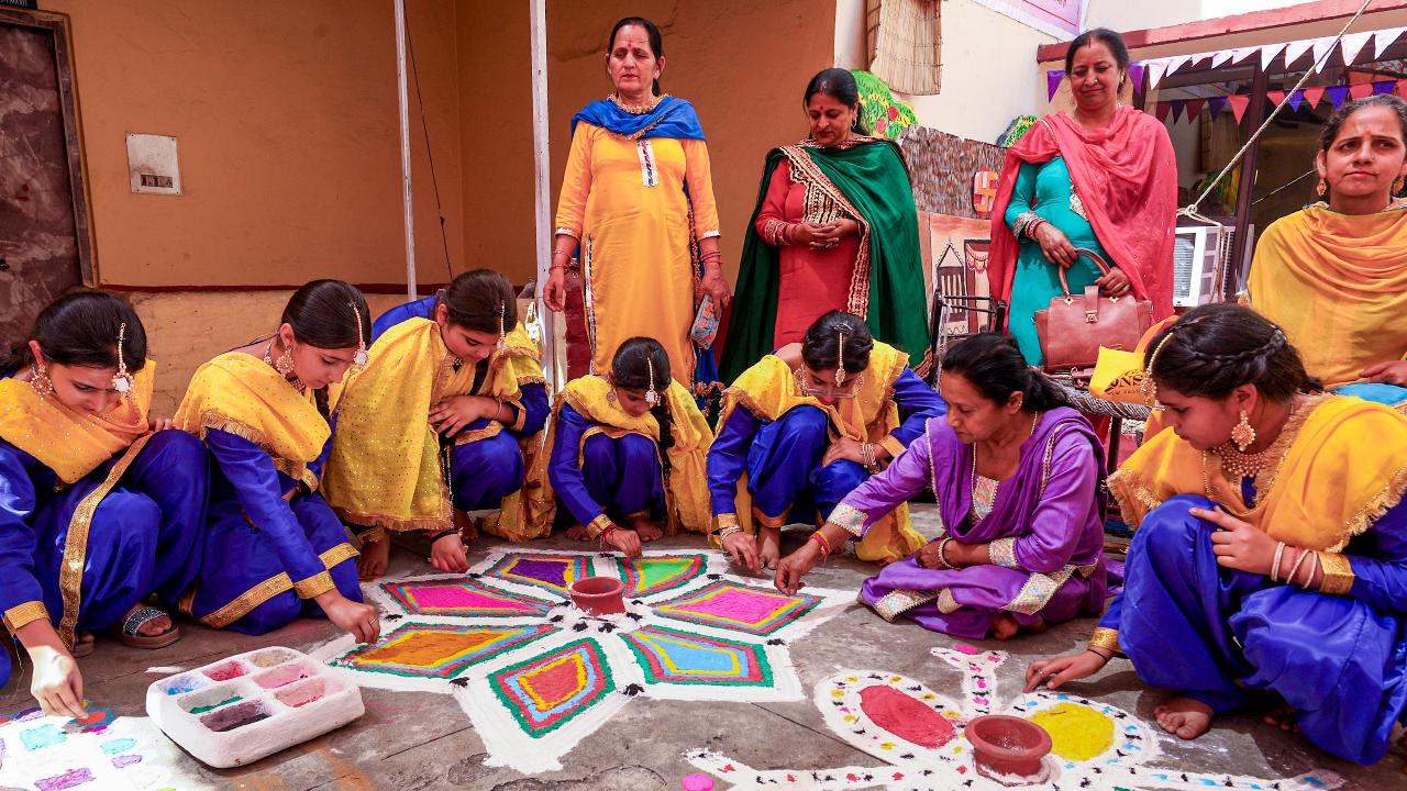 Students make rangolis during the Duggar Mela, an annual cultural festival organized by the Dogra Sadar Sabha, marking the &lsquo;Baisakhi&rsquo; festival celebrations, in Jammu