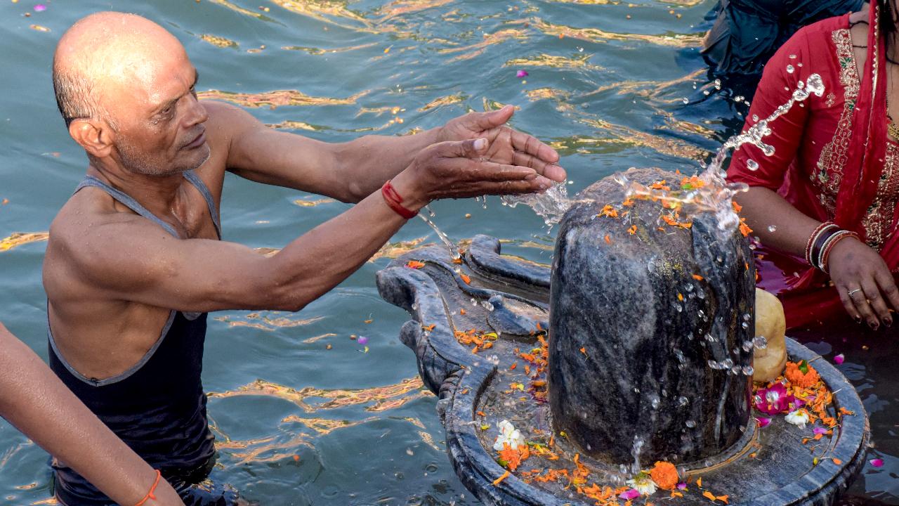 A person takes a holy dip in the Ganga river and offer prayers to Lord Shiva on the eve of the 'Baisakhi' festival, at Har Ki Pauri, in Haridwar, Uttarakhand, Monday, April 13