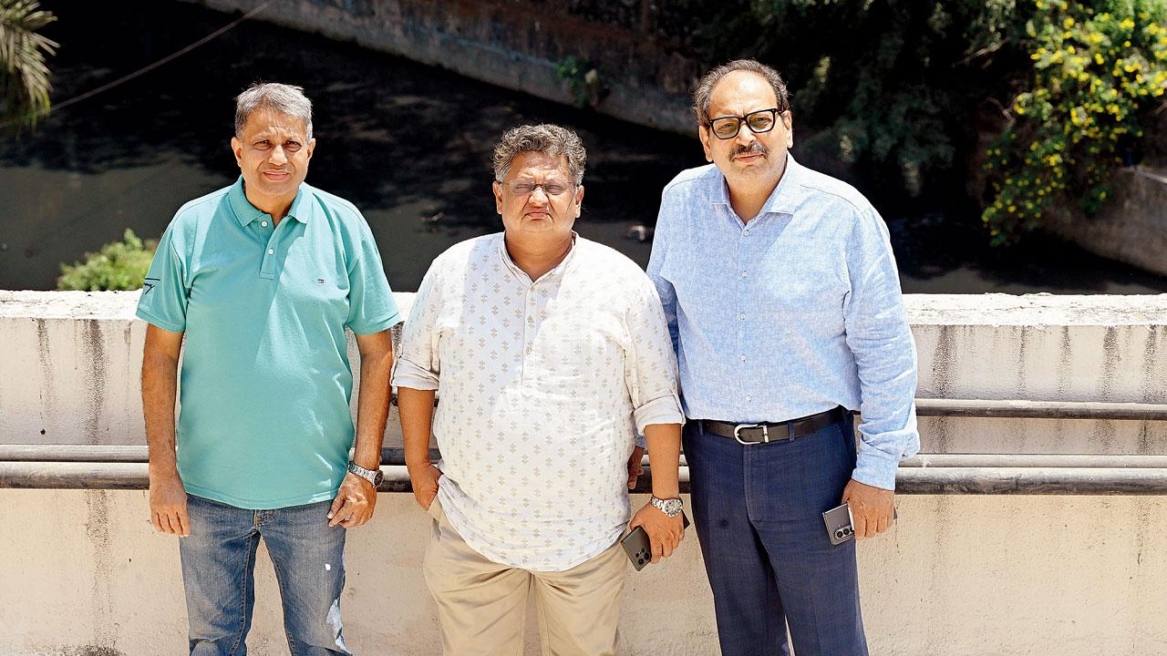 Anand Shirali, Sandesh Kadam, and Mukesh Sanghavi on a building terrace in the area