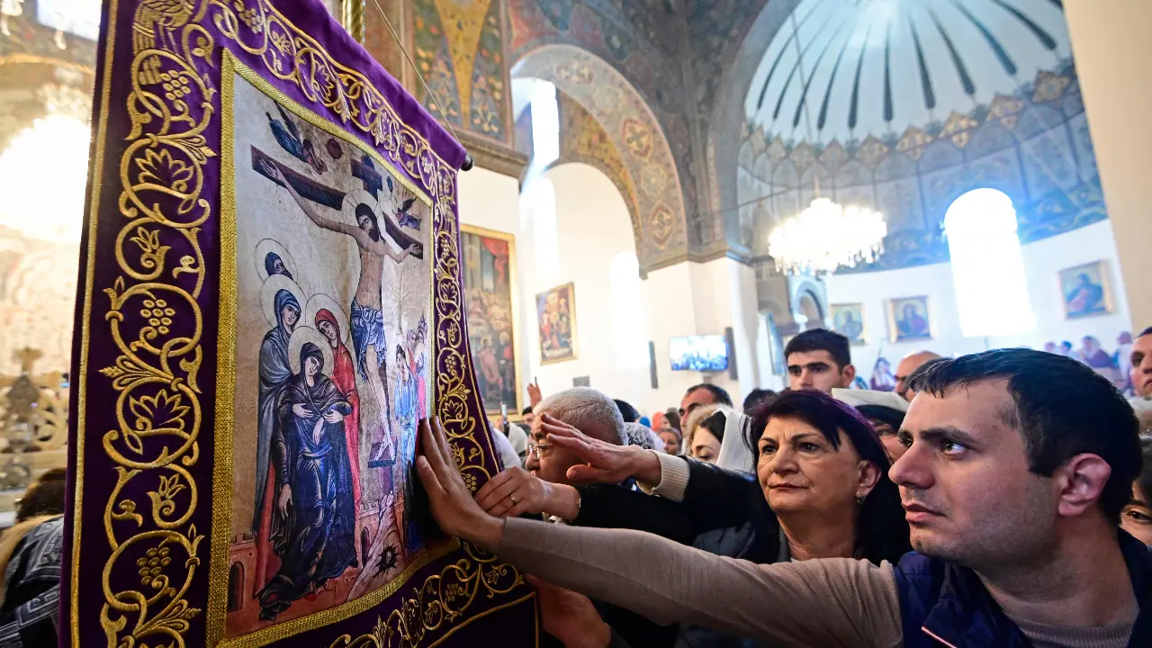 Faithfuls of the Armenian Apostolic Church pray as they attend the Easter service conducted by Supreme Patriarch and head of the Catholicos of All Armenians Garegin II (Karekin II) at the Church of Holy Etchmiadzin, in Echmiadzin on April 5