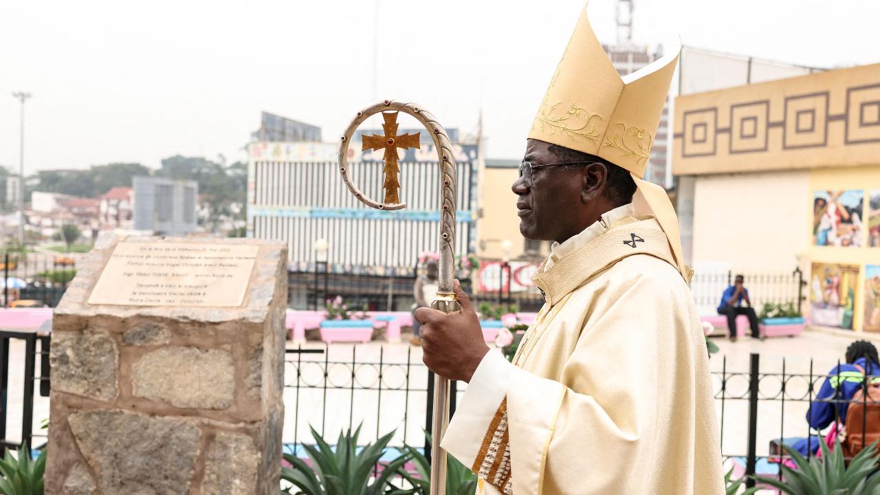 Archbishop of Yaounde Jean Mbarga stands in the courtyard of Notre Dame des Victoires Cathedral before the start of Easter Mass in Yaounde, Cameroon, on April 5