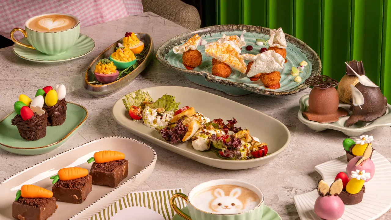 An Indian EasterStep into Kadak at ICONIQA for Easter brunch. The experience begins with interactive live stations, where guests can enjoy made-to-order egg preparations including omelettes, scrambled eggs, and egg bhurji, alongside a lively chaat station serving favourites such as pani puri, palak patta chaat, aloo tikki chaat, and samosa chaat. Fresh and wholesome salads like quinoa with pomegranate and feta, kachumber, and sprouts add a light, seasonal touch, perfectly complemented by a warm bowl of creamy carrot ginger soup.
The starters set the tone for indulgence with an eclectic mix of flavours—from crisp veg spring rolls to robust Indian classics like mutton cutlet, Amritsari prawns, and murgh banjara kebab. The main course is a lavish spread that brings together global influences and Indian comfort, featuring dishes such as roast chicken with jus and root vegetables, pan-fried seabass in lemon butter sauce, veg Hakka noodles, and Kung Pao chicken. Guests can also savour hearty Indian favourites including chicken biryani, mutton rogan josh, dal makhani, paneer makhani, Malabar fish curry, jeera rice, and exotic vegetables in black pepper sauce.
Indulge in desserts that include chocolate Easter nests, mini egg cheesecakes, classic carrot cake, fresh fruit tarts, Easter cupcakes, mini éclairs, and Easter cookies.
Where: Kadak, ICONIQA Hotel, near Mumbai International Airport, Andheri EastWhen: April 5Time: 12 noon - 4 pmPrice: Rs 1,799 plus taxes per person