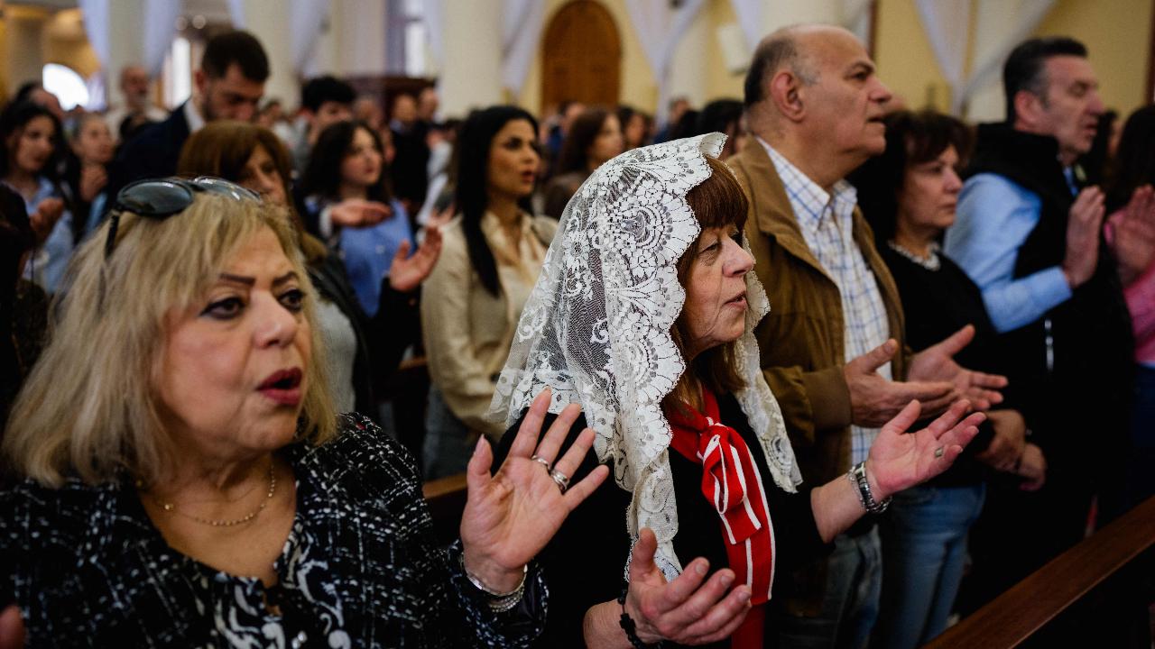 Lebanese Maronite Christian worshippers pray during the Easter Sunday service at the Saint Antoine Church in Beirut on April 5, 2026. Lebanon was drawn into the Middle East war on March 2 when Tehran-backed militant group Hezbollah launched attacks on Israel to avenge the killing of the Iranian leader. Israel has responded with broad strikes across Lebanon and a ground offensive