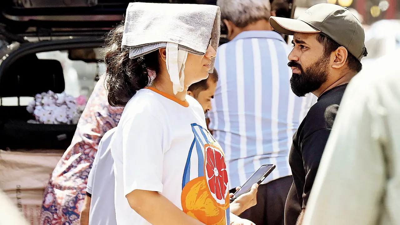 People step out amid intense heat near Abdul Rehman Street, opposite Crawford Market (Ashish Raje)