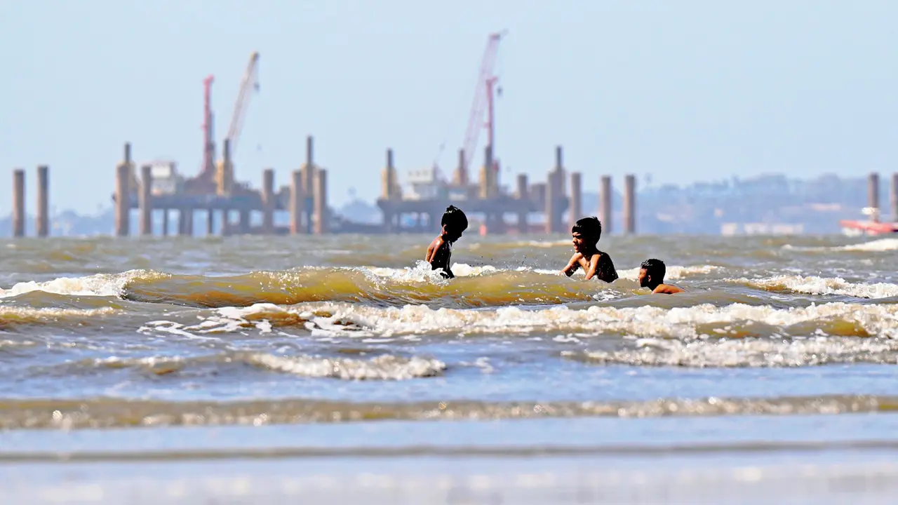 Boys dive into the sea near Juhu Koliwada, beating the heat with a refreshing swim amid the scorching summer sun (Pic/Satej Shinde)
