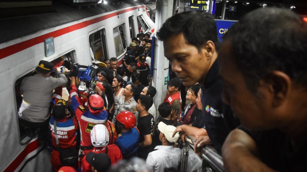 Rescuers work at the site of a train collision after a passenger train locomotive pierced through the rear car of a commuter train at Bekasi Timur station in Bekasi, West Java, in Indonesia on Tuesday. PIC/AFP