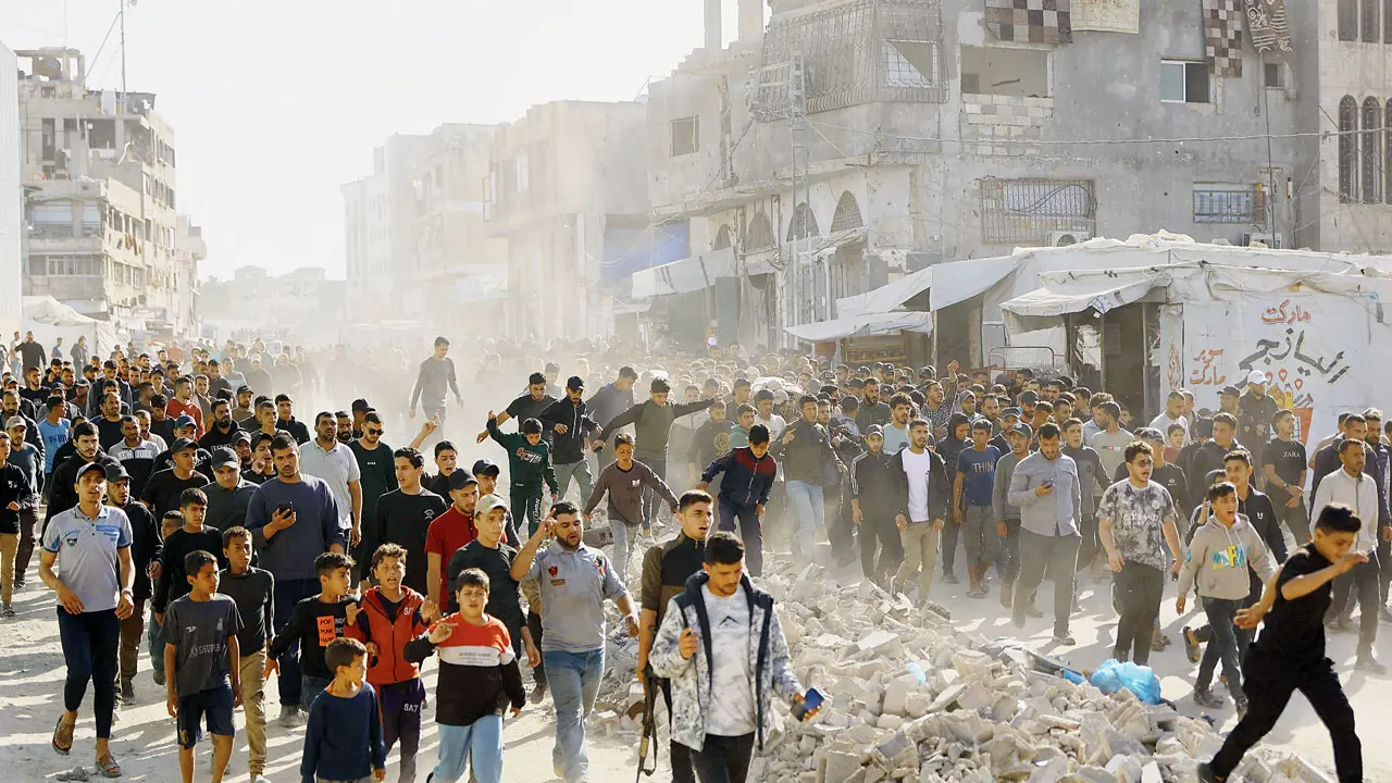 Displaced Palestinians attend the funeral of people killed by an Israeli strike that targeted a vehicle in Gaza City, on Tuesday. Pic/AFP
