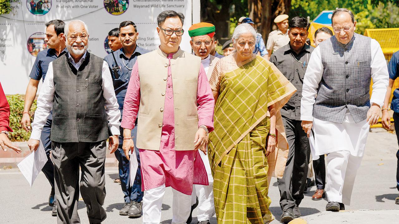 Union Parliamentary Affairs Minister Kiren Rijiju (in pink), along with Union Finance Minister Nirmala Sitharaman, met the Election Commission on  Wednesday