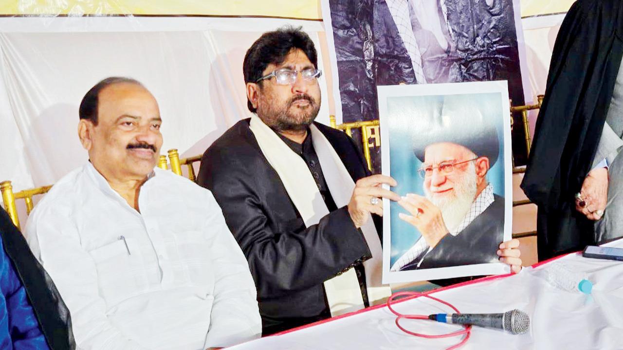 AISPLB Board Secretary Maulana Yasub Abbas holds a picture of Ayatollah Ali Khamenei