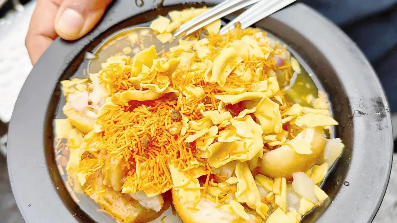 <p><strong>Pav meets pani puri</strong><br />In Chembur&rsquo;s Sindhi Camp, you&rsquo;ll spot two stalls with the same name. Pick the one with the loud digital board. Try the Butter Papdi Chaat here, an invention by Mumbai&rsquo;s Sindhis who moved to the city post-Partition. Created originally in Ulhasnagar, it features a mini kadak pav base layered with potato, chutneys, farsan, and chilled pani puri water that makes the kadak pav soft to eat. It&rsquo;s ideal on a hot day when you need a chilled, tangy bite.&nbsp;</p>
<p><strong>At </strong>Sindh Pani Puri, CG Road, Chembur Colony, Chembur.&nbsp;<br /><strong>Call </strong>8898131313<br /><strong>Cost</strong> Rs 60 per plate</p>