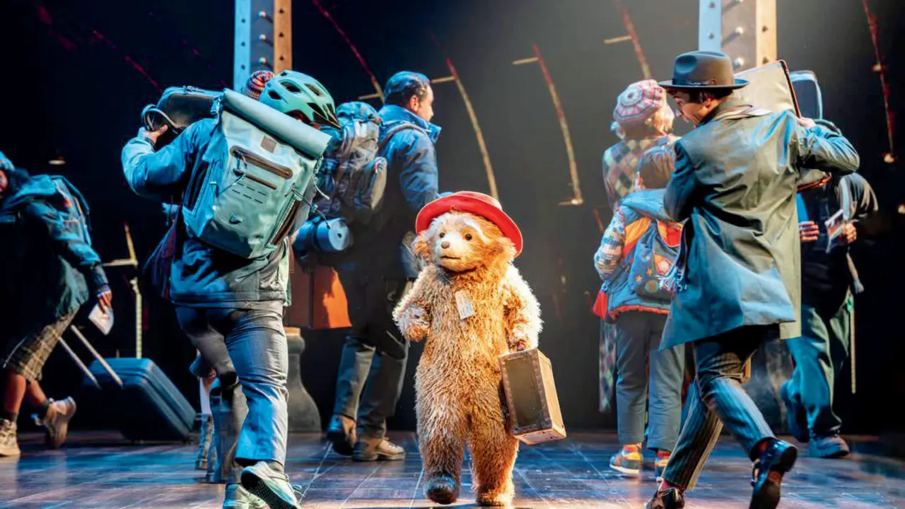 Arti Shah (centre) performs in the Paddington costume onstage
