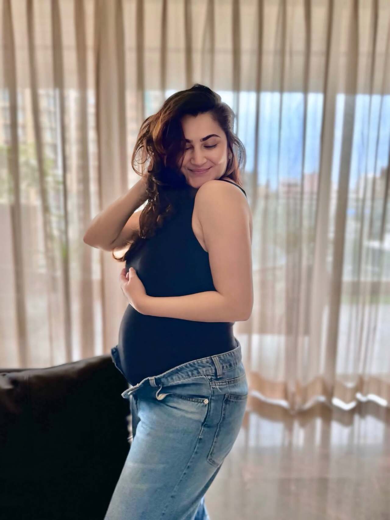 Shivaleeka Oberoi embraces effortless maternity fashion with a cool, off-duty vibe in a black tee and jeans. The look strikes the perfect balance between comfort and style.