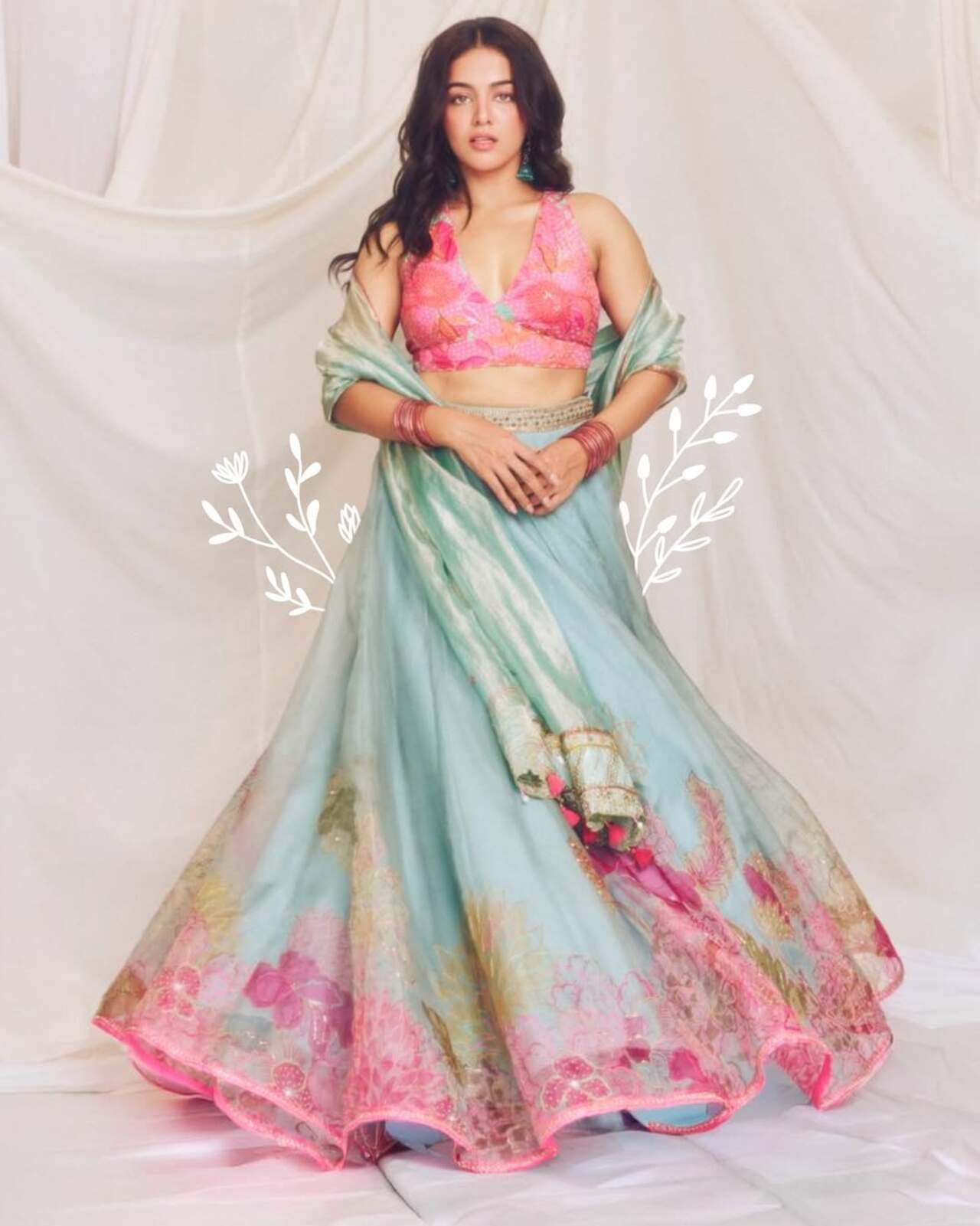 Wamiqa Gabbi looks fresh and festive in this beautiful Holi-inspired outfit. She wears a vibrant pink floral blouse paired with a flowy pastel blue lehenga.